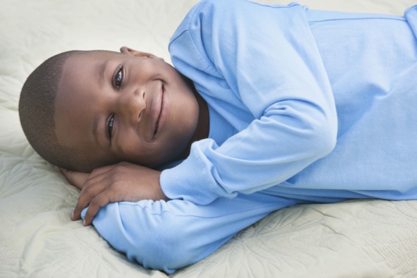 African American boy smiling on picnic blanket