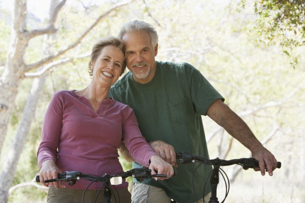 Senior Caucasian couple riding bicycles on rural path