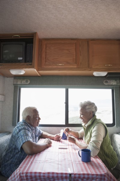 Mixed race Senior couple having coffee in RV