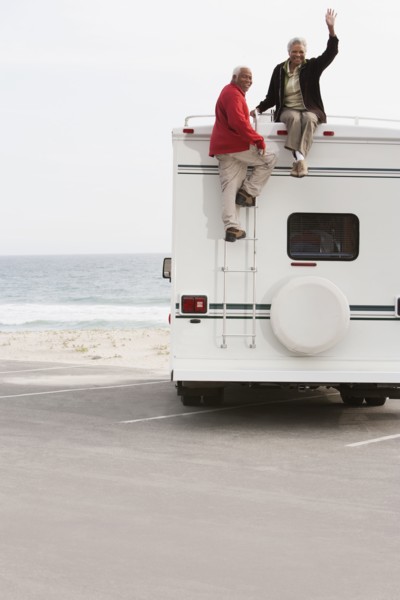 Mixed race Senior couple sitting on RV