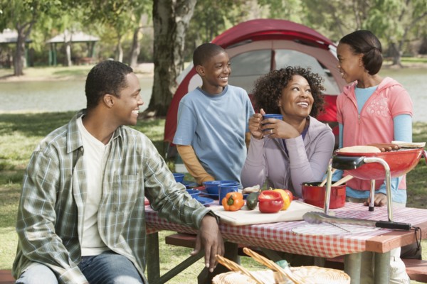 Family cooking together at campsite