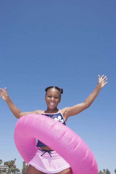 African American girl playing with inner tube