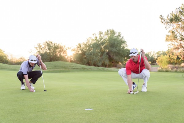 Golfers aiming on golf course