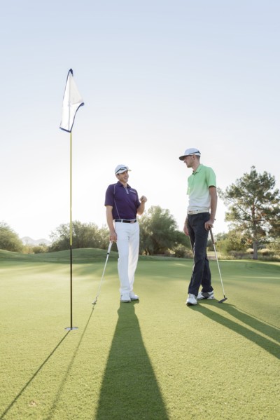 Friends talking on golf course
