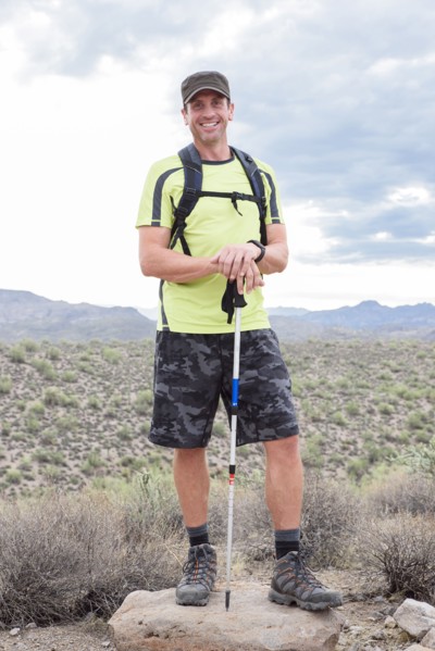 Portrait of smiling Hispanic man hiking in desert