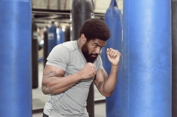 Black man using punching bag