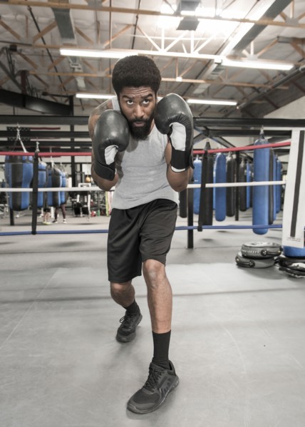 Black man posing in boxing ring