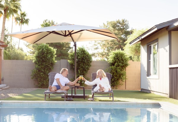 Caucasian couple toasting near swimming pool