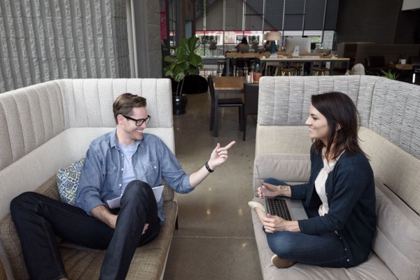 Caucasian couple sitting on sofas talking