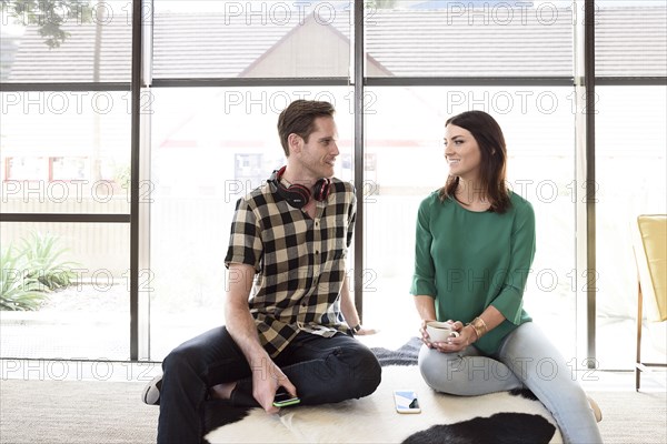 Caucasian couple relaxing on bench
