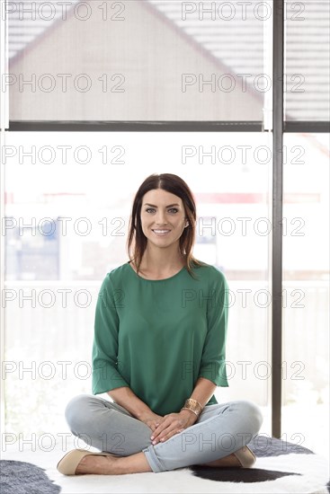 Portrait of smiling Caucasian woman sitting on bench