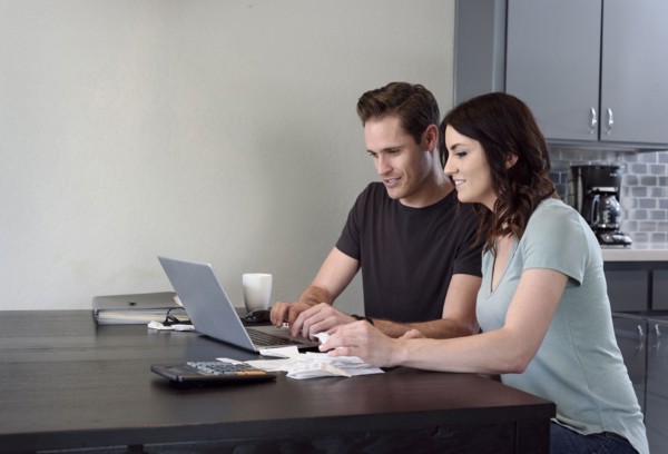 Caucasian couple using laptop