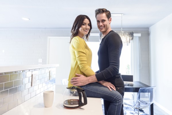 Portrait of Caucasian couple embracing on kitchen counter