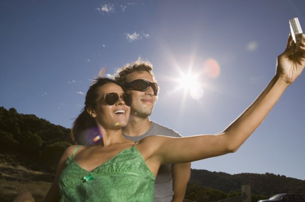 Couple taking self-portrait with camera