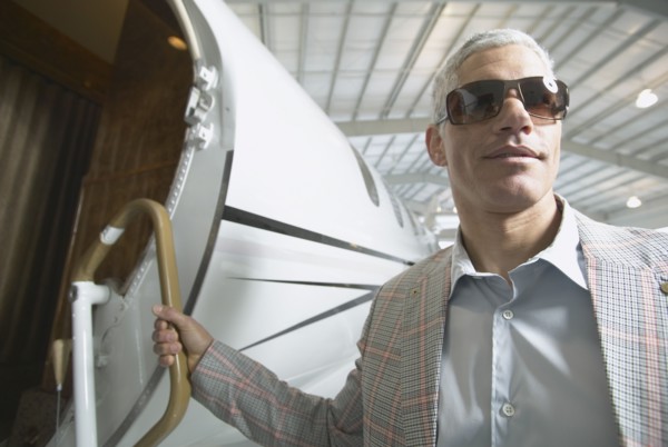 Middle-aged man boarding airplane in hanger