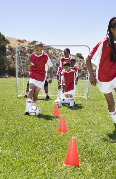 Multi-ethnic children playing soccer