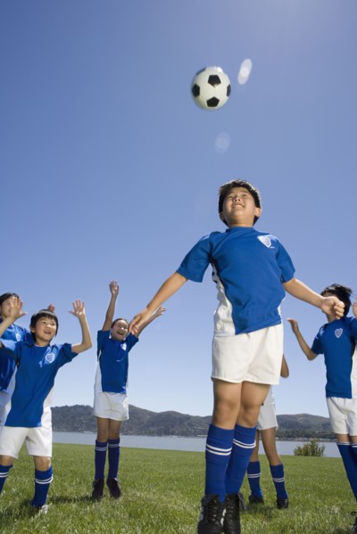 Multi-ethnic children playing soccer