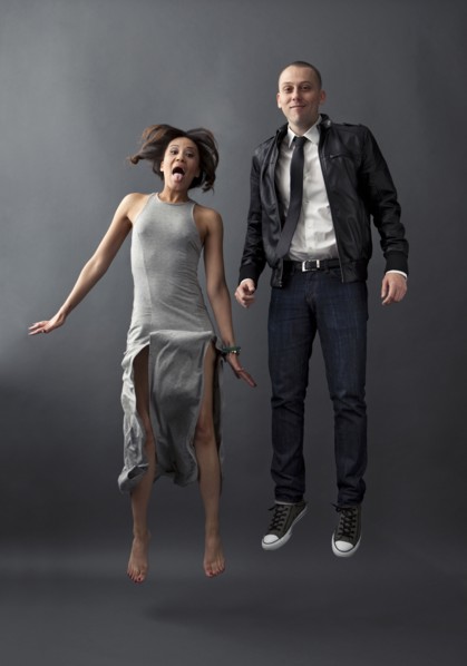 Couple jumping together in studio