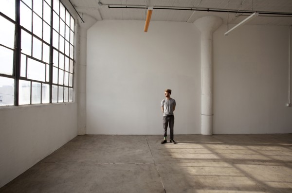Caucasian man standing in empty loft