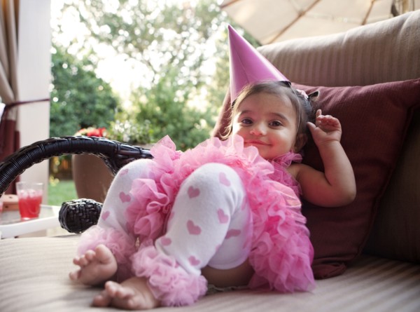Smiling mixed girl wearing party hat