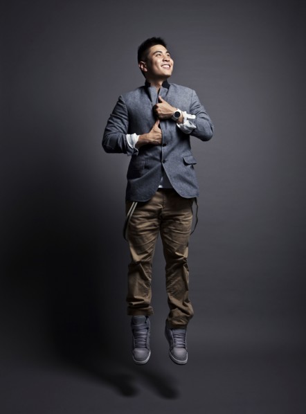 Chinese man wearing jacket and jumping
