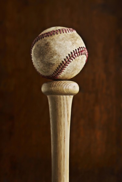 Baseball balancing on baseball bat