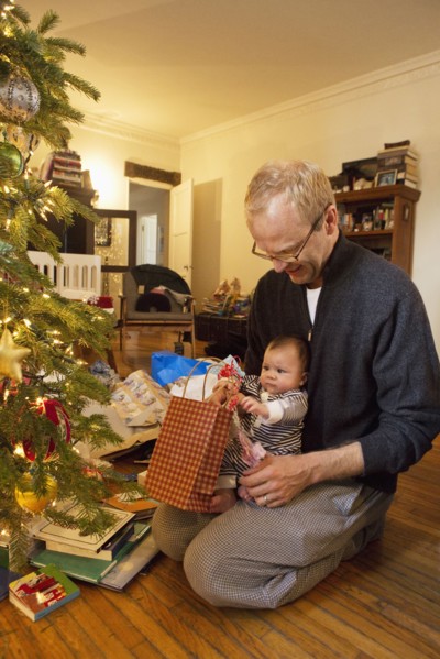 Father and baby boy opening Christmas gifts