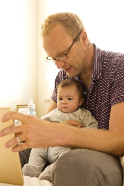 Father reading to baby boy
