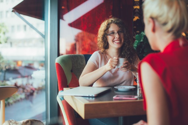Women drinking coffee together in cafe