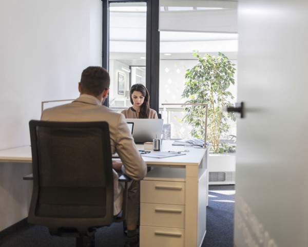 Caucasian business people working at desks in office