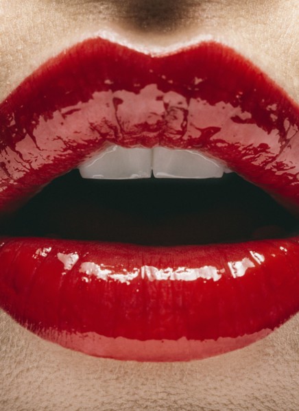 Close up of mouth of woman wearing red lipstick