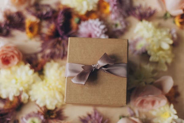 Close up of wrapped gift and flowers