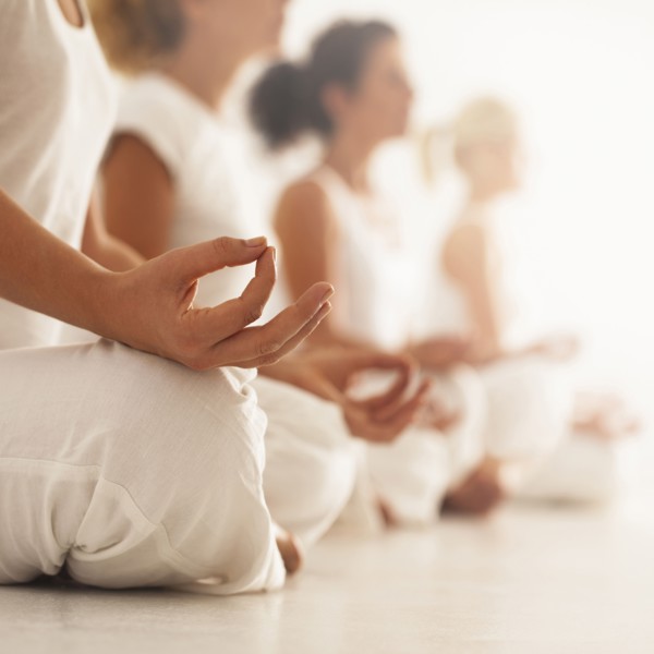 Close up of women meditating in yoga class