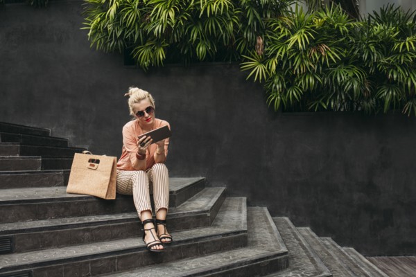 Caucasian woman using digital tablet on stairs