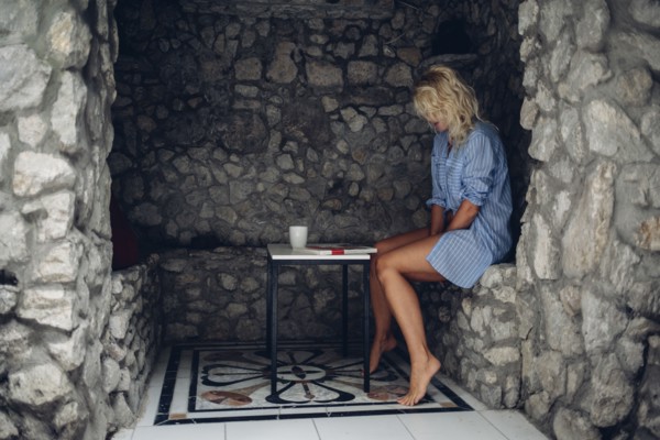 Woman sitting in stone patio