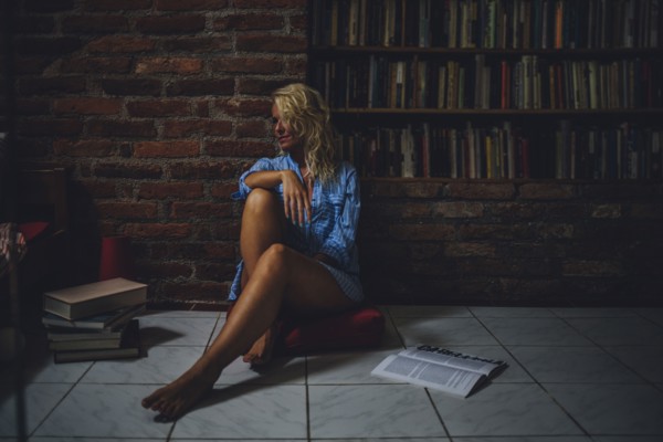 Smiling woman sitting on living room floor