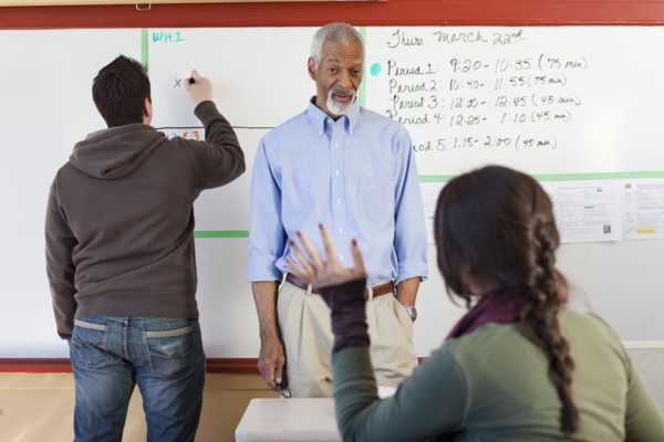 Teacher and students talking in classroom
