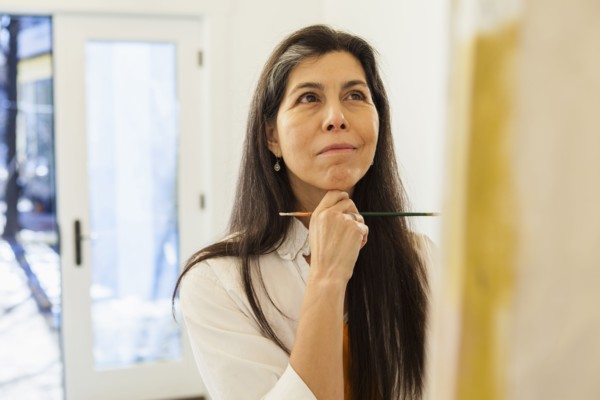 Hispanic artist working in studio