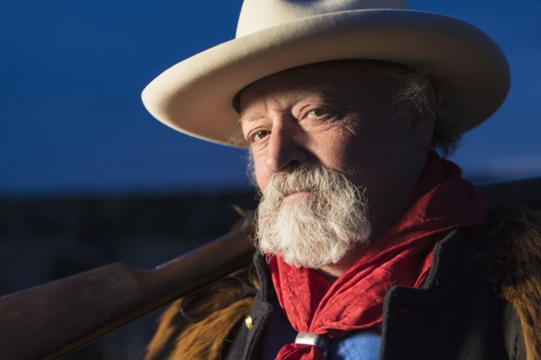 Caucasian man holding gun outdoors