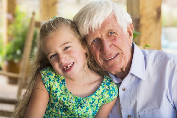 Caucasian man and granddaughter smiling