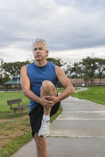 Hispanic man stretching outdoors