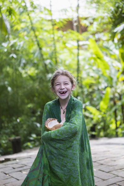 Caucasian girl wrapped in blanket