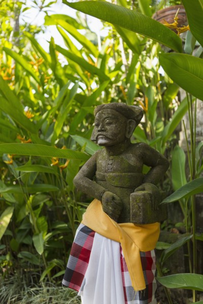 Hindu statue wrapped in fabric in garden