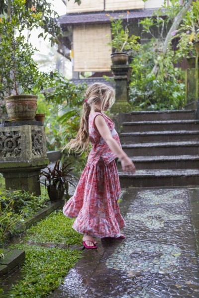 Caucasian girl dancing on wet patio