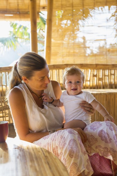Caucasian mother and baby relaxing in living room