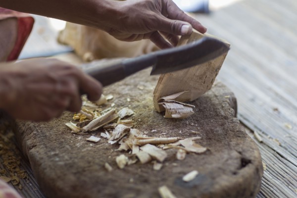 Wood worker chiseling piece in studio