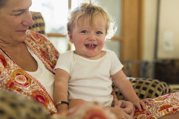 Caucasian mother holding toddler in living room