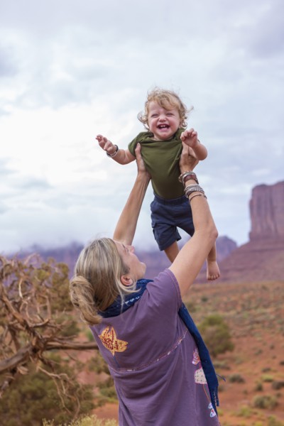 Caucasian mother and son playing in desert