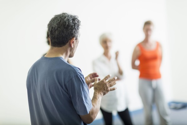 Teacher talking to students in acting class