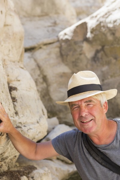 Older Caucasian man exploring rock formations